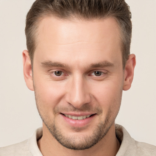 Joyful white young-adult male with short  brown hair and brown eyes