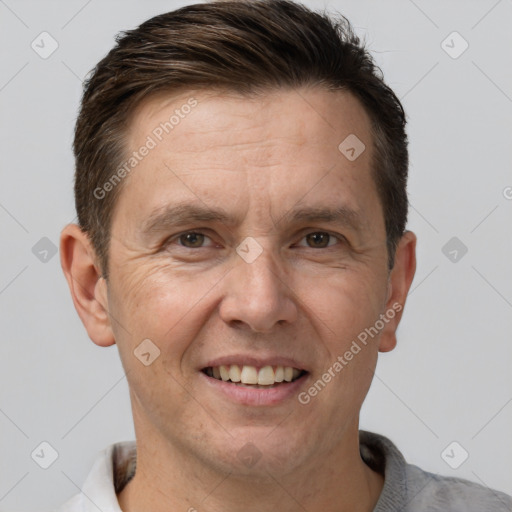 Joyful white adult male with short  brown hair and brown eyes