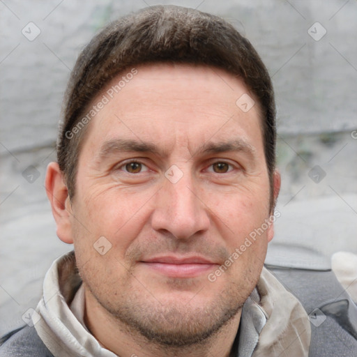 Joyful white adult male with short  brown hair and grey eyes