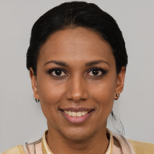 Joyful latino young-adult female with short  black hair and brown eyes