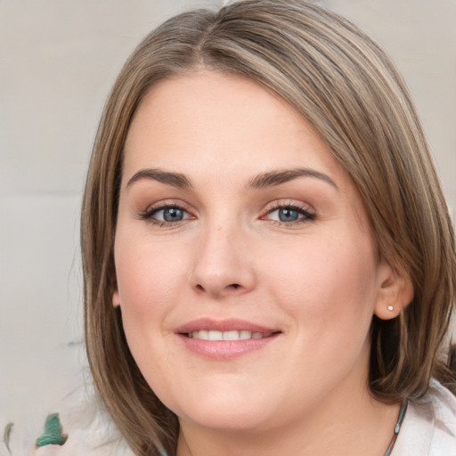 Joyful white young-adult female with medium  brown hair and blue eyes