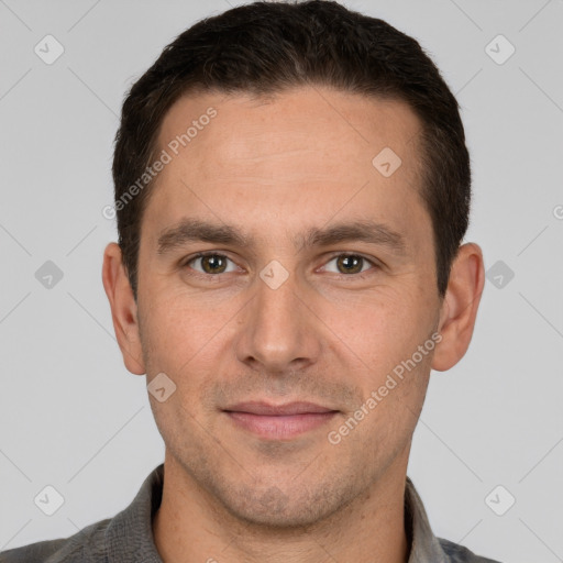 Joyful white adult male with short  brown hair and brown eyes