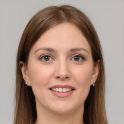 Joyful white young-adult female with long  brown hair and grey eyes