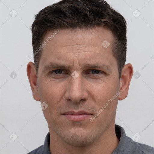 Joyful white adult male with short  brown hair and grey eyes