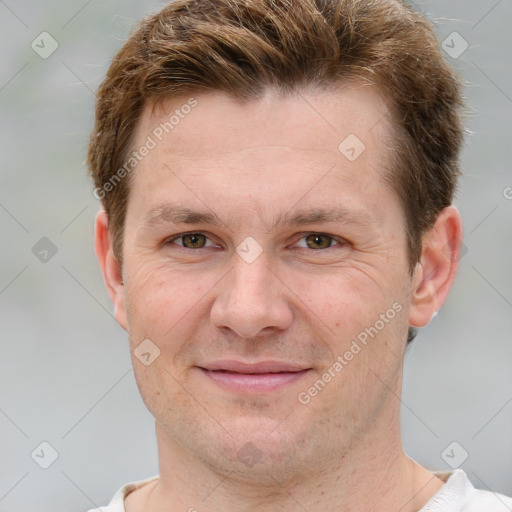 Joyful white adult male with short  brown hair and grey eyes