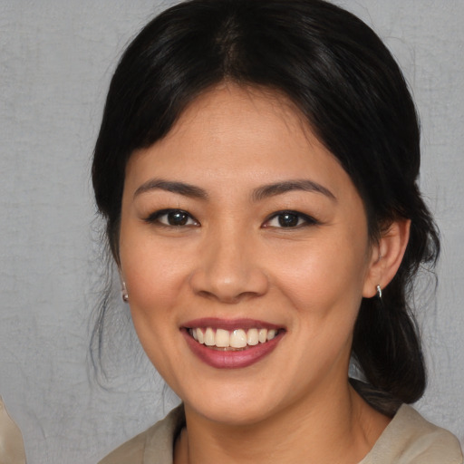 Joyful asian young-adult female with medium  brown hair and brown eyes