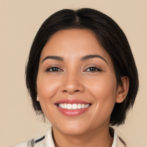 Joyful latino young-adult female with medium  brown hair and brown eyes