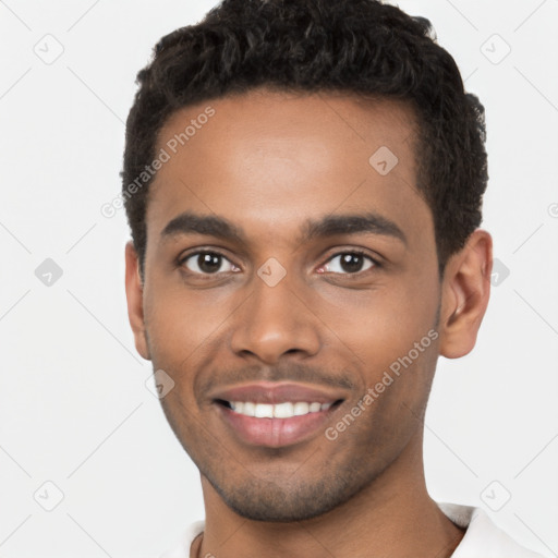 Joyful black young-adult male with short  brown hair and brown eyes