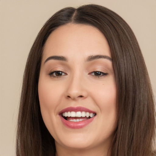 Joyful white young-adult female with long  brown hair and brown eyes