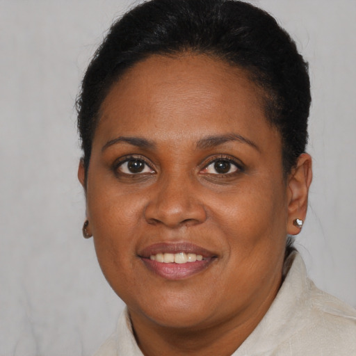 Joyful black young-adult female with short  brown hair and brown eyes