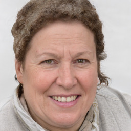 Joyful white adult female with short  brown hair and blue eyes