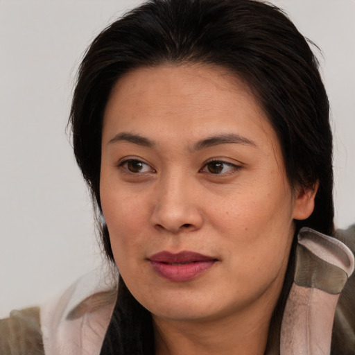 Joyful asian young-adult female with medium  brown hair and brown eyes