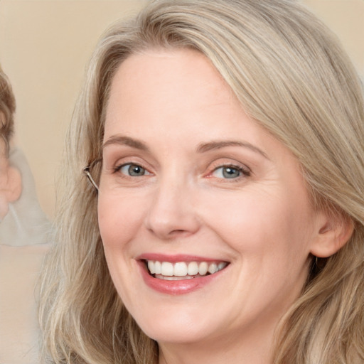 Joyful white adult female with long  brown hair and grey eyes