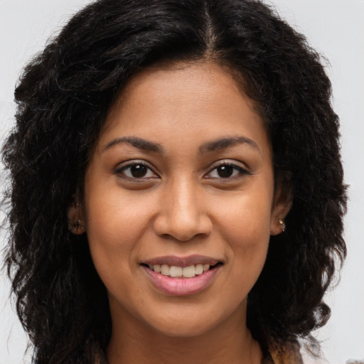 Joyful latino young-adult female with long  brown hair and brown eyes