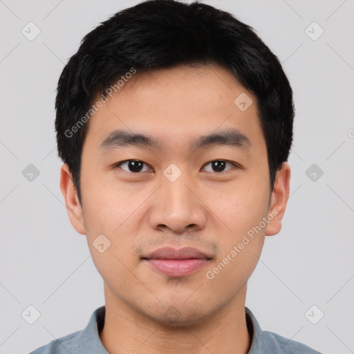 Joyful asian young-adult male with short  black hair and brown eyes