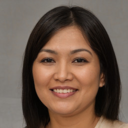 Joyful asian young-adult female with medium  brown hair and brown eyes