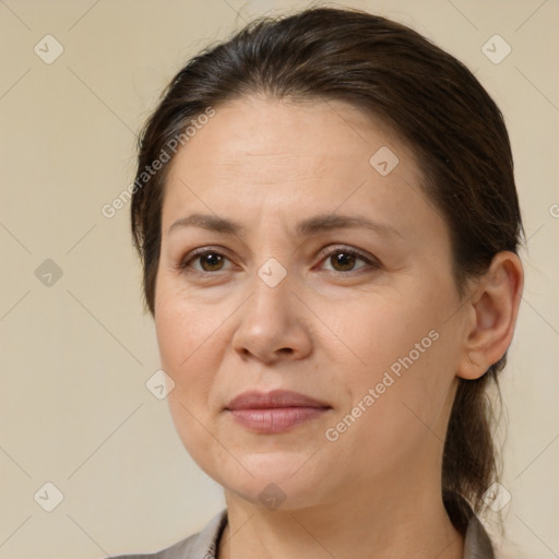 Joyful white adult female with medium  brown hair and brown eyes