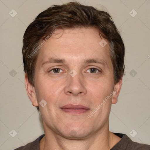 Joyful white adult male with short  brown hair and grey eyes