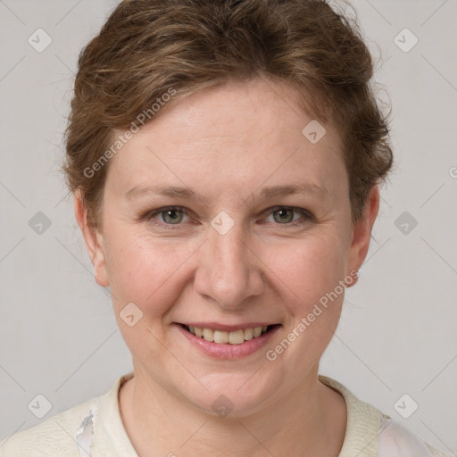 Joyful white young-adult female with short  brown hair and grey eyes