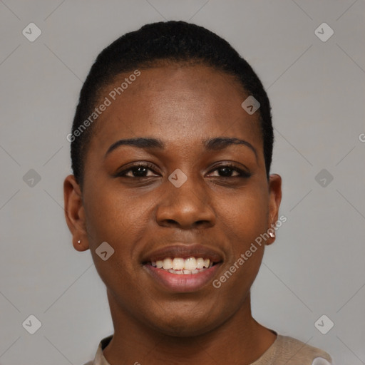 Joyful black young-adult female with short  black hair and brown eyes