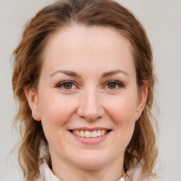 Joyful white young-adult female with medium  brown hair and green eyes