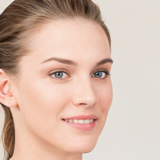 Joyful white young-adult female with long  brown hair and blue eyes