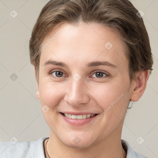 Joyful white young-adult female with short  brown hair and grey eyes