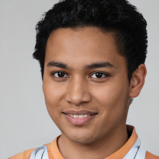 Joyful latino young-adult male with short  black hair and brown eyes