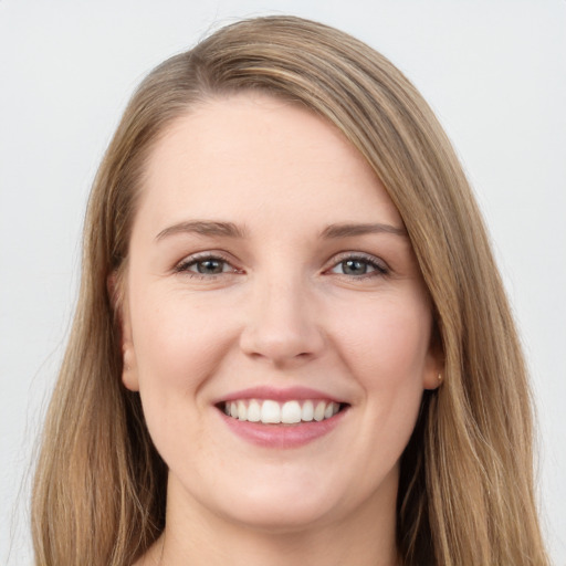 Joyful white young-adult female with long  brown hair and grey eyes