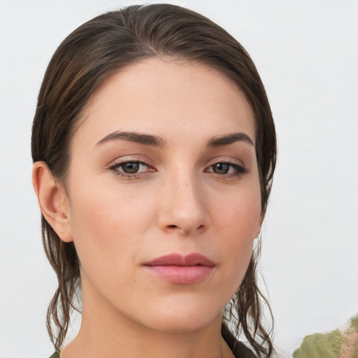 Joyful white young-adult female with medium  brown hair and grey eyes