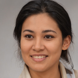 Joyful latino young-adult female with medium  brown hair and brown eyes