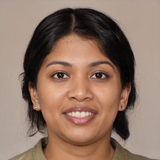 Joyful latino young-adult female with medium  black hair and brown eyes
