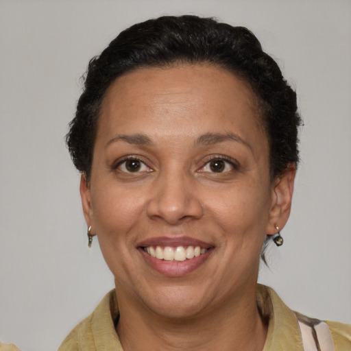 Joyful latino adult female with short  brown hair and brown eyes