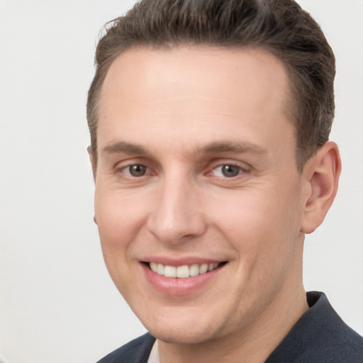 Joyful white young-adult male with short  brown hair and brown eyes