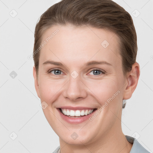 Joyful white young-adult female with short  brown hair and grey eyes