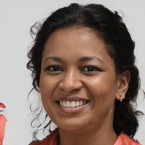 Joyful black young-adult female with long  brown hair and brown eyes