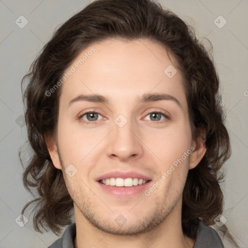 Joyful white young-adult male with medium  brown hair and brown eyes