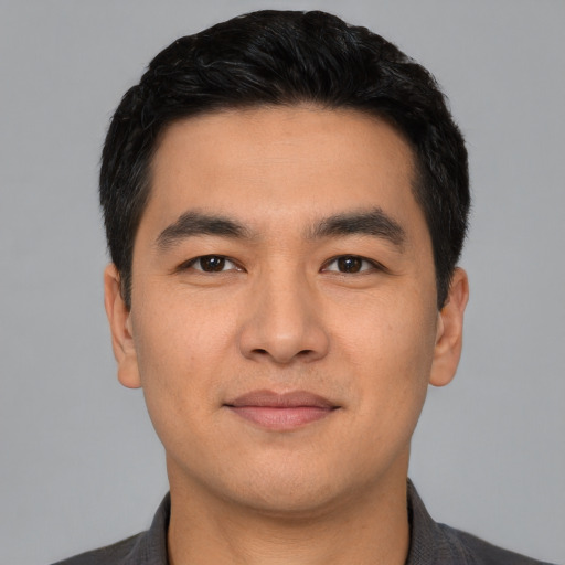 Joyful latino young-adult male with short  black hair and brown eyes