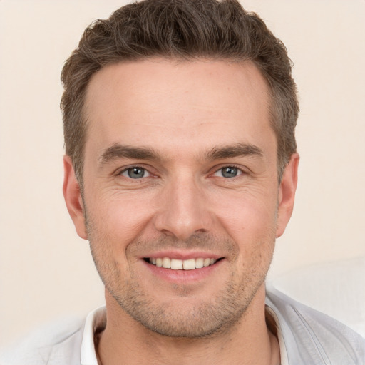 Joyful white young-adult male with short  brown hair and brown eyes