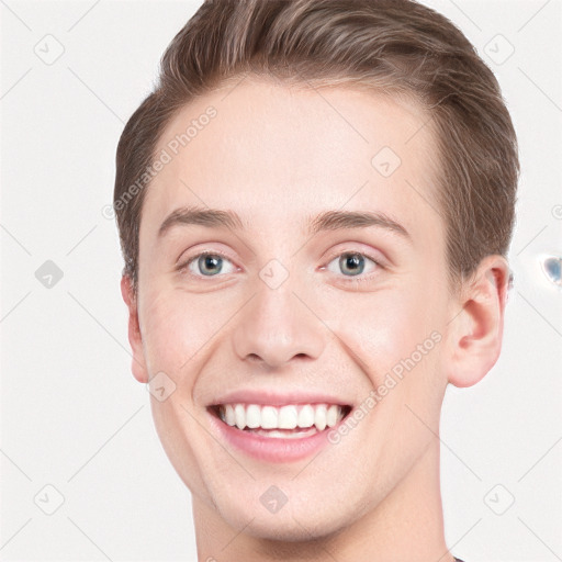 Joyful white young-adult male with short  brown hair and grey eyes