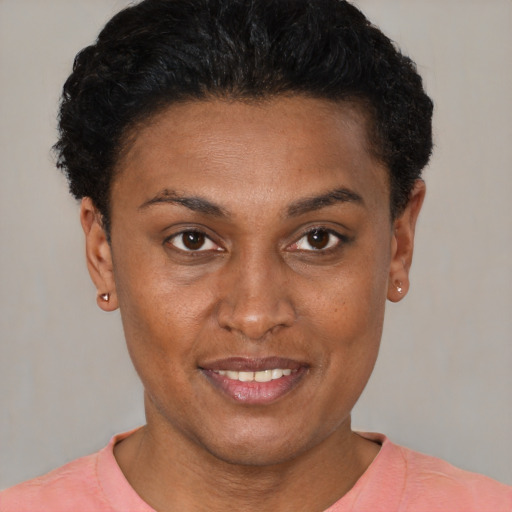 Joyful black young-adult female with short  brown hair and brown eyes