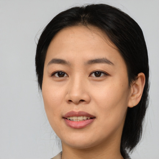 Joyful asian young-adult female with medium  brown hair and brown eyes