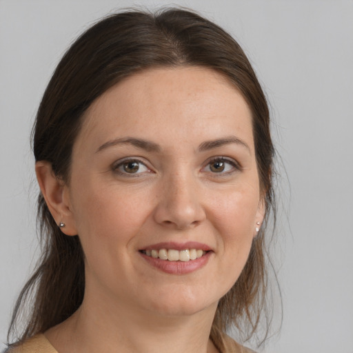 Joyful white young-adult female with medium  brown hair and brown eyes