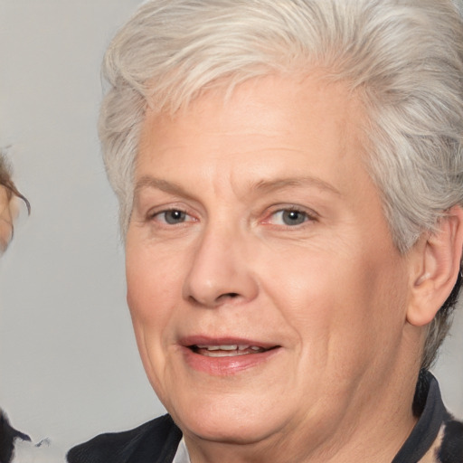 Joyful white middle-aged female with medium  gray hair and brown eyes