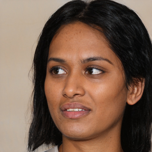 Joyful asian young-adult female with long  black hair and brown eyes