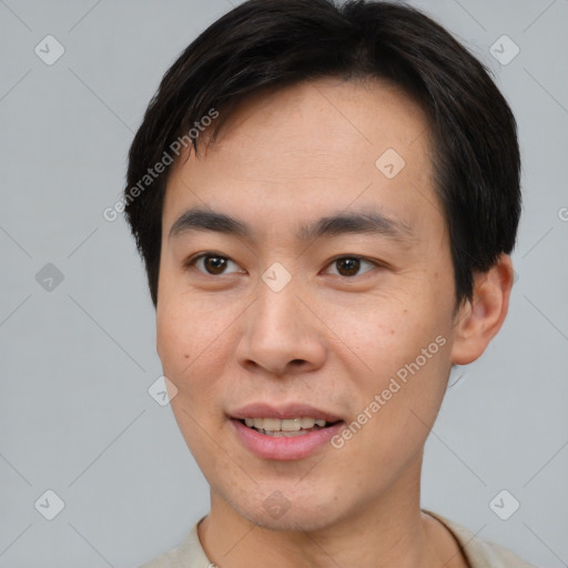 Joyful asian young-adult male with short  brown hair and brown eyes