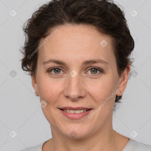 Joyful white adult female with short  brown hair and brown eyes