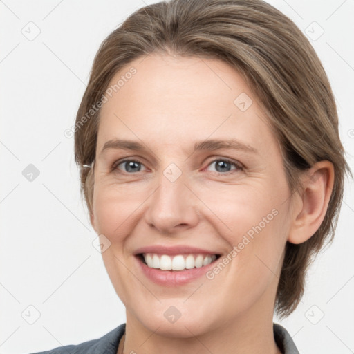 Joyful white young-adult female with medium  brown hair and grey eyes