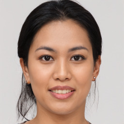 Joyful asian young-adult female with medium  brown hair and brown eyes