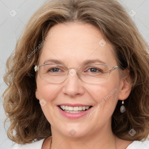 Joyful white adult female with medium  brown hair and blue eyes